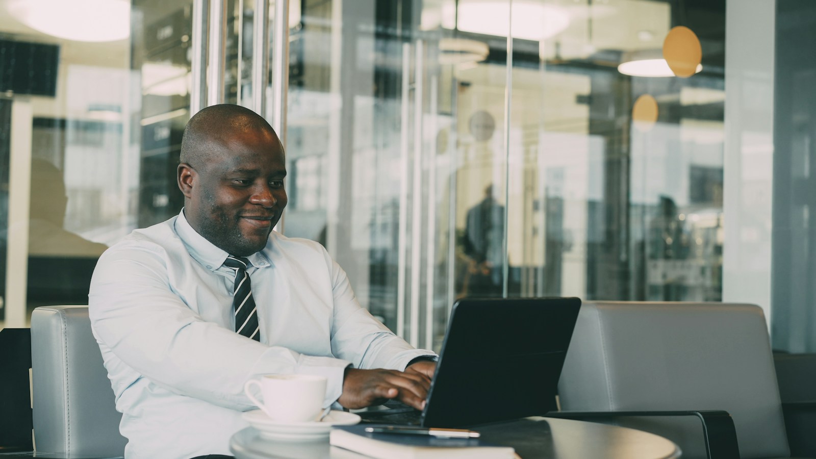 A business professional using a laptop in a café